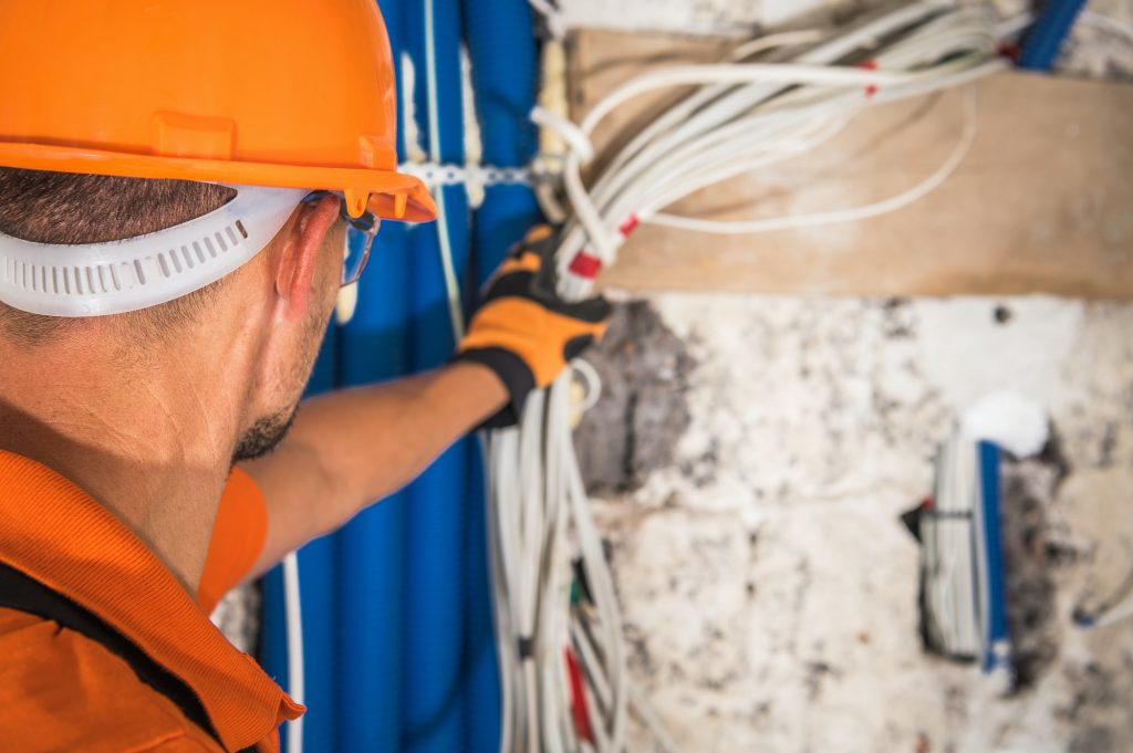 Construction Contractor Looking Inside Electrical Installation
